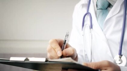 depositphotos 387118764 stock video doctor writing patient notes on 1