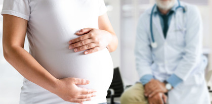 pregnant woman and gynecologist doctor at hospital